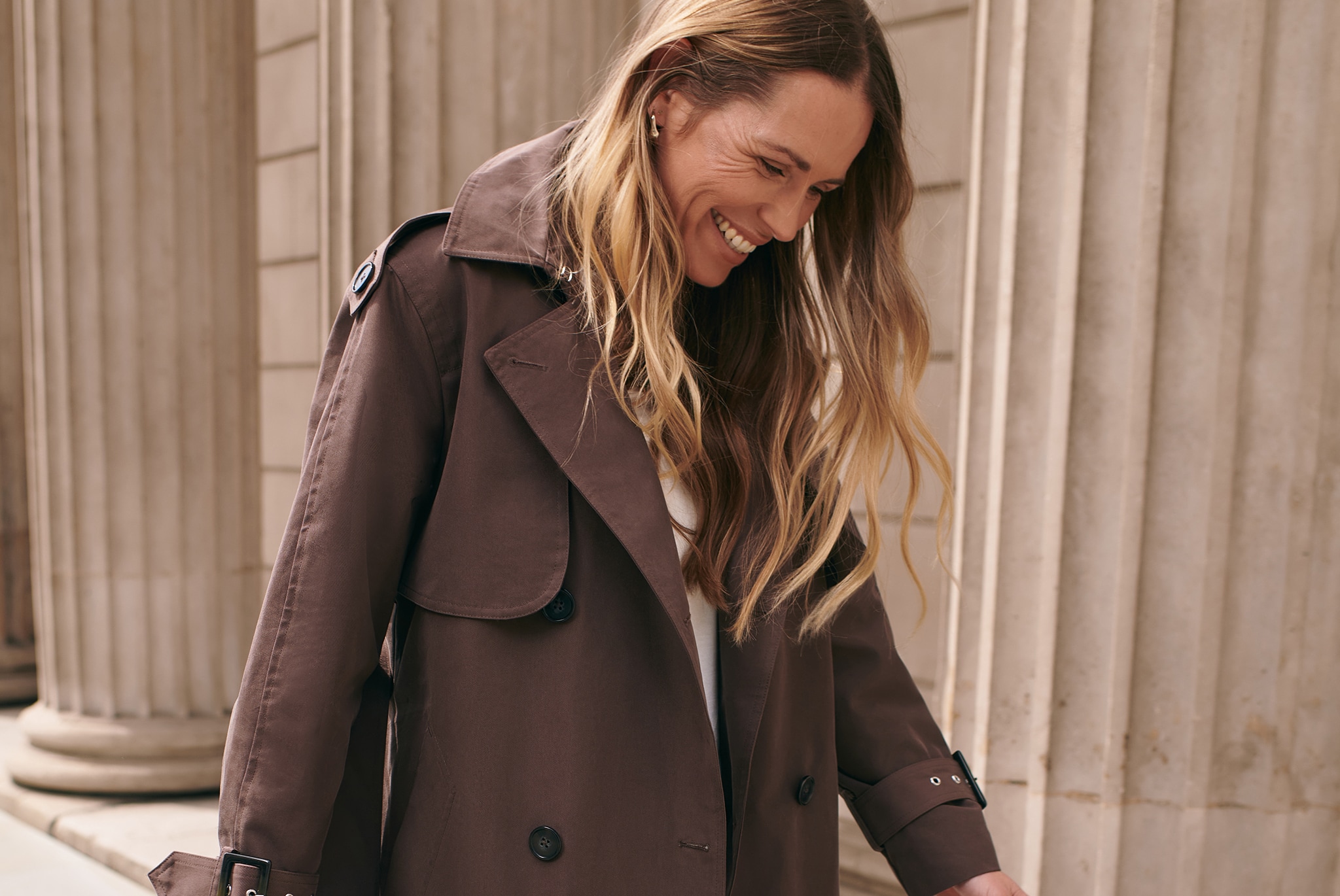Model walks in the city and wears Anthology Elevated Trench Coat