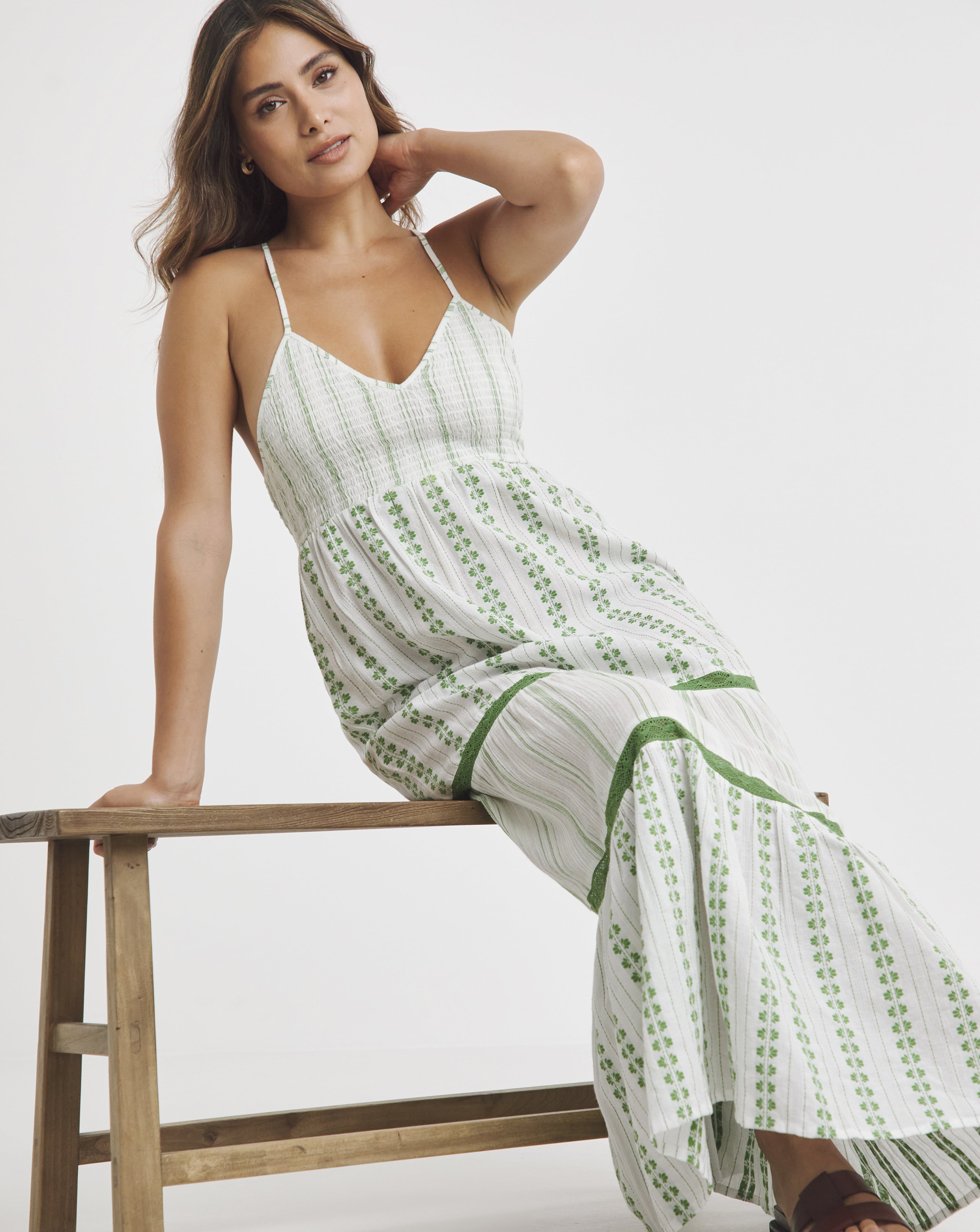 A woman wearing a light green long summer dress